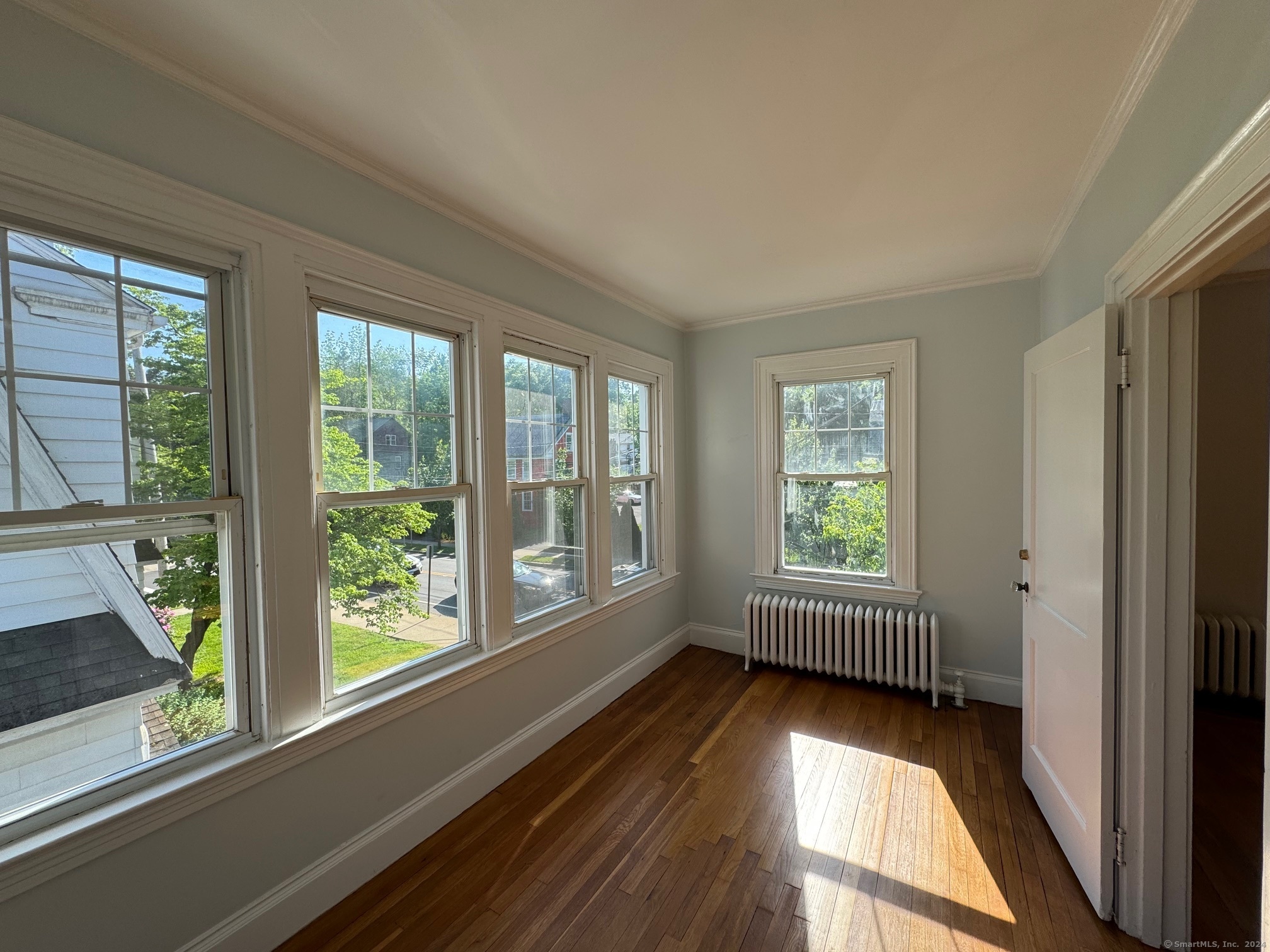 1253 Forest Road, Unit 2 New Haven, CT 06515 - Photo 13 of 30 a view of empty room with wooden floor and fan