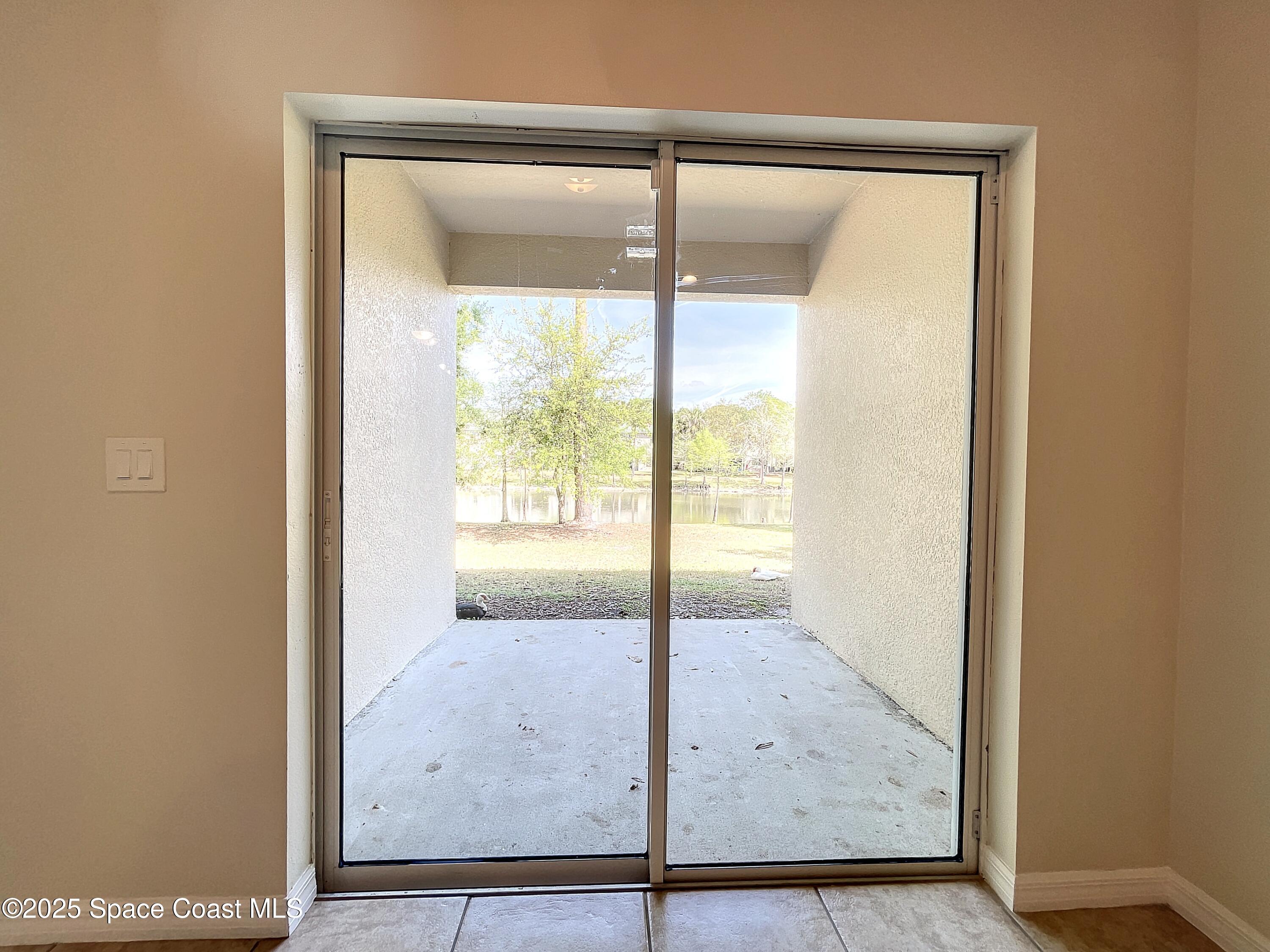 3737 Chambers Lane, Unit 3 Cocoa, FL 32926 - Photo 11 of 25 an empty room with wooden floor and outdoor view