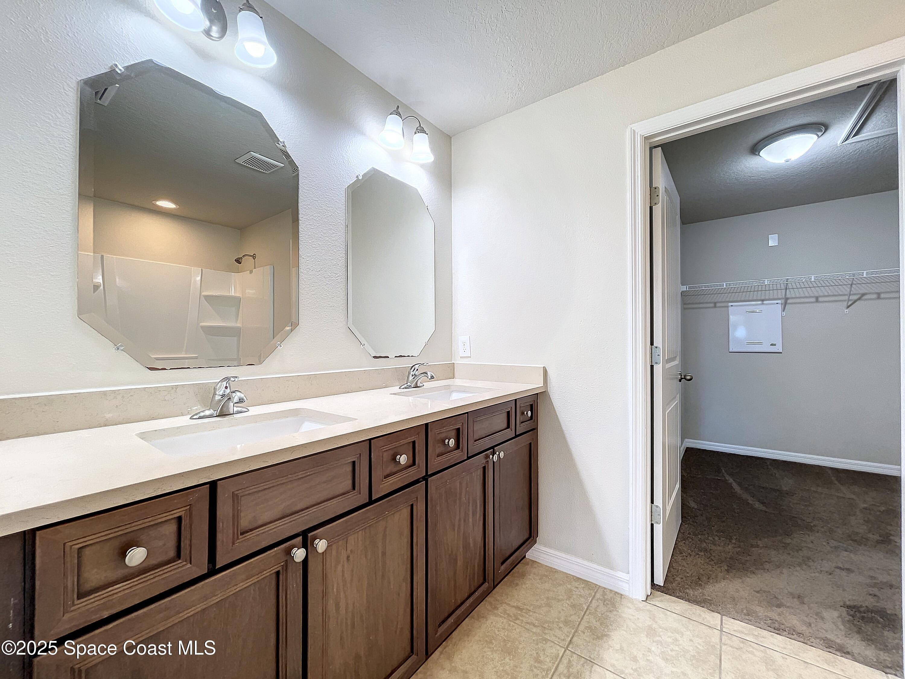 3737 Chambers Lane, Unit 3 Cocoa, FL 32926 - Photo 15 of 25 a bathroom with a double vanity sink and a mirror