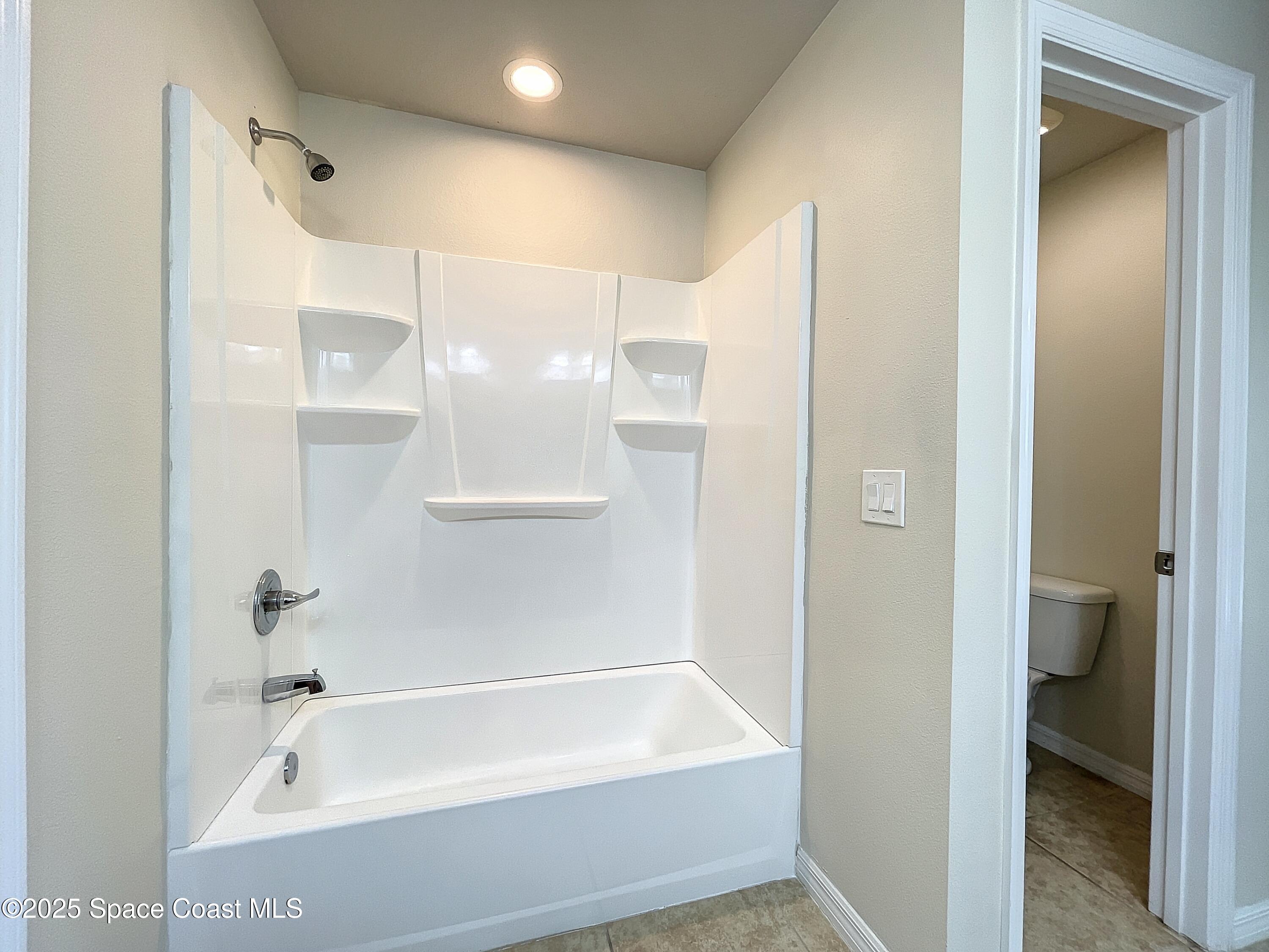 3737 Chambers Lane, Unit 3 Cocoa, FL 32926 - Photo 16 of 25 a bathroom with a bathtub and a shower
