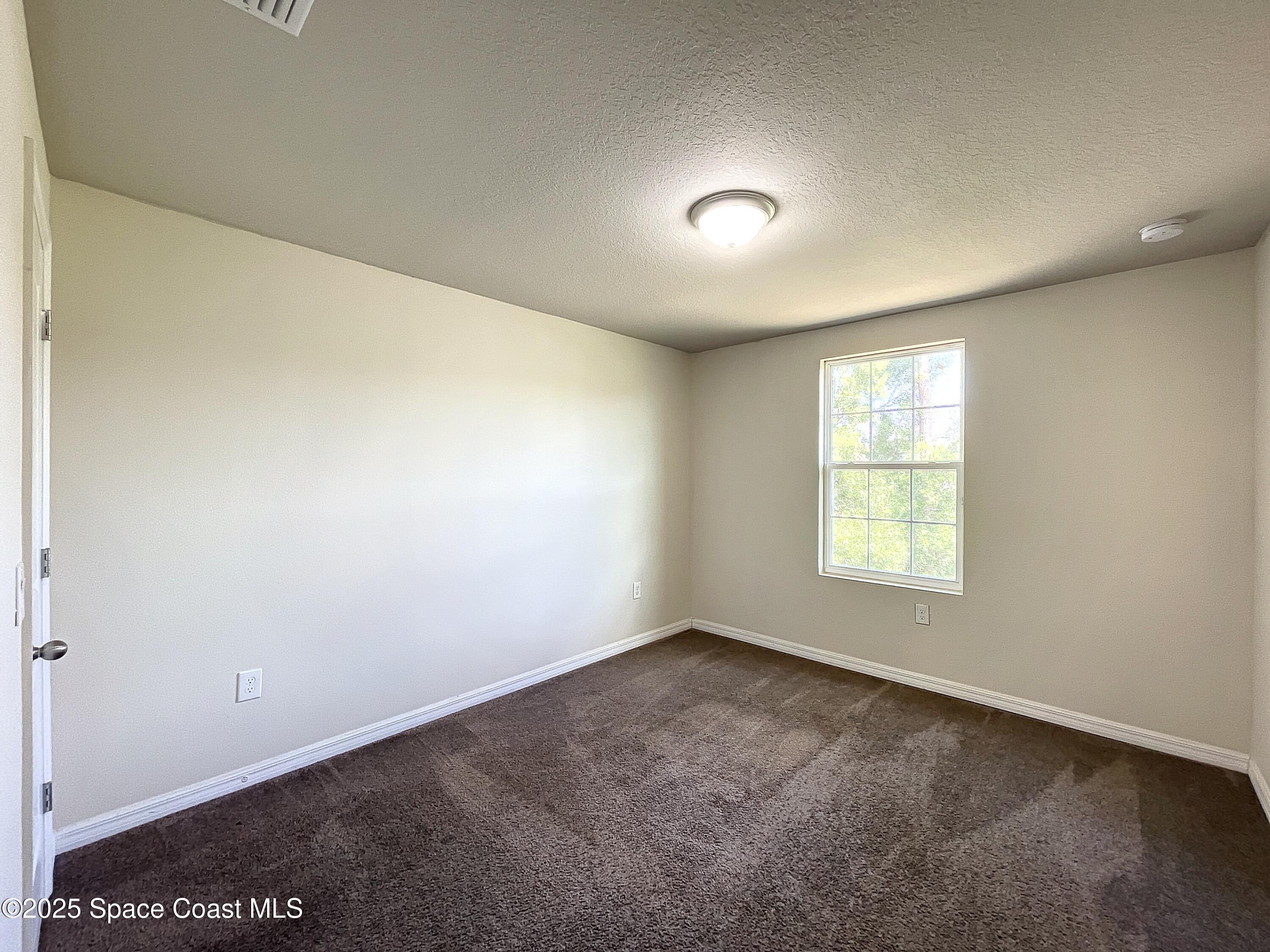 3737 Chambers Lane, Unit 3 Cocoa, FL 32926 - Photo 19 of 25 an empty room with a window