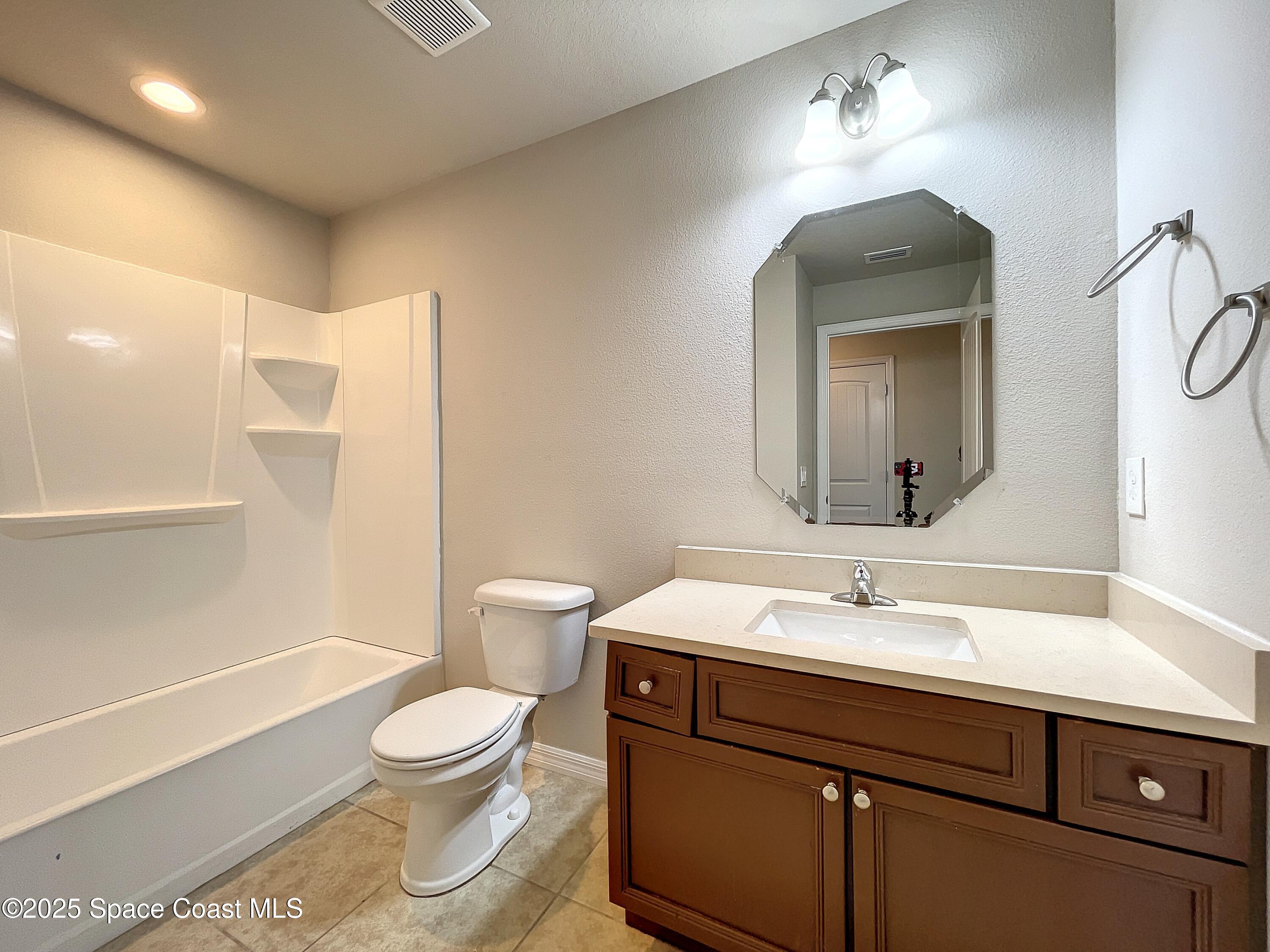 3737 Chambers Lane, Unit 3 Cocoa, FL 32926 - Photo 21 of 25 a bathroom with a toilet sink and mirror
