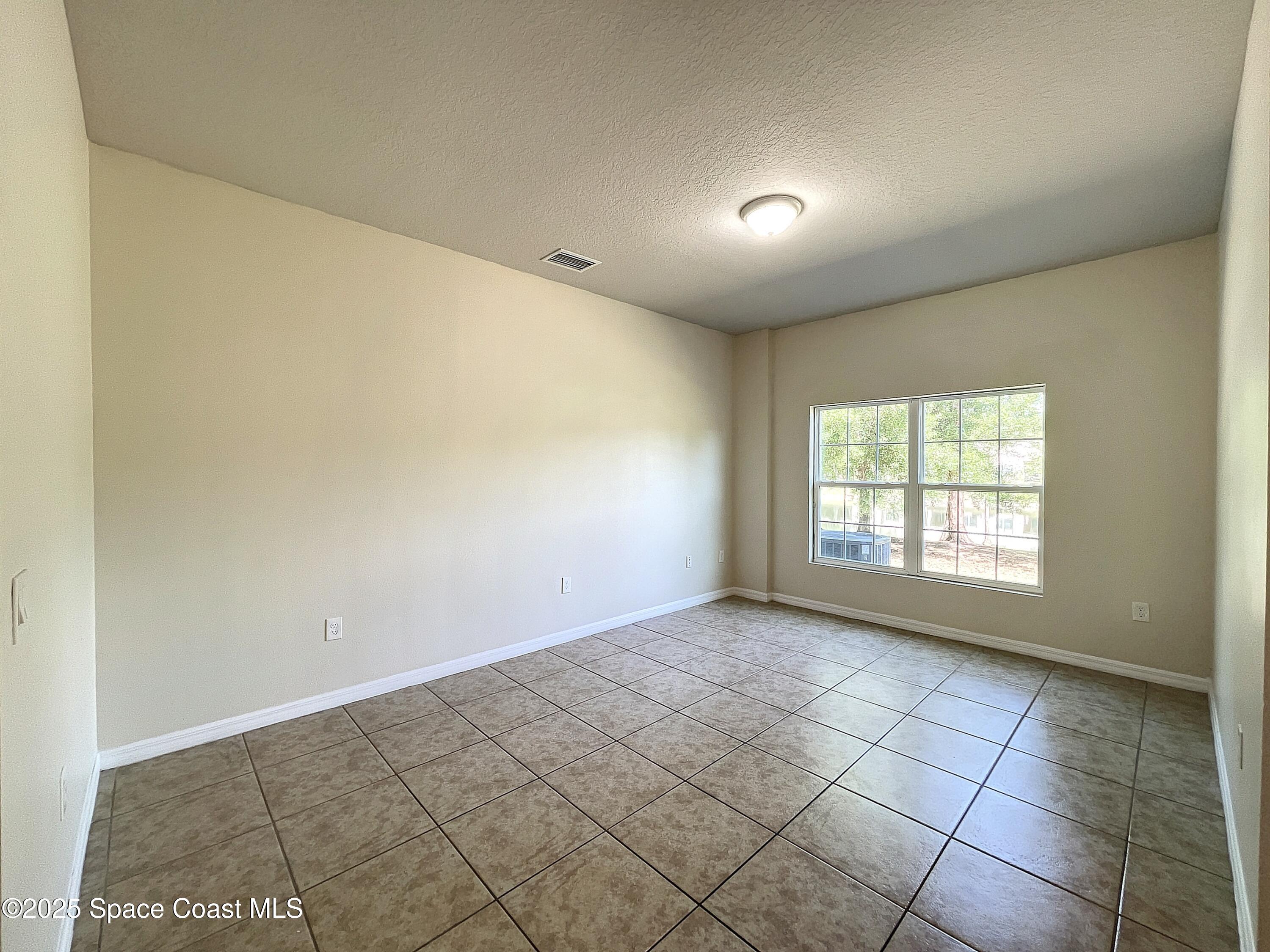 3737 Chambers Lane, Unit 3 Cocoa, FL 32926 - Photo 7 of 25 a view of an empty room and window