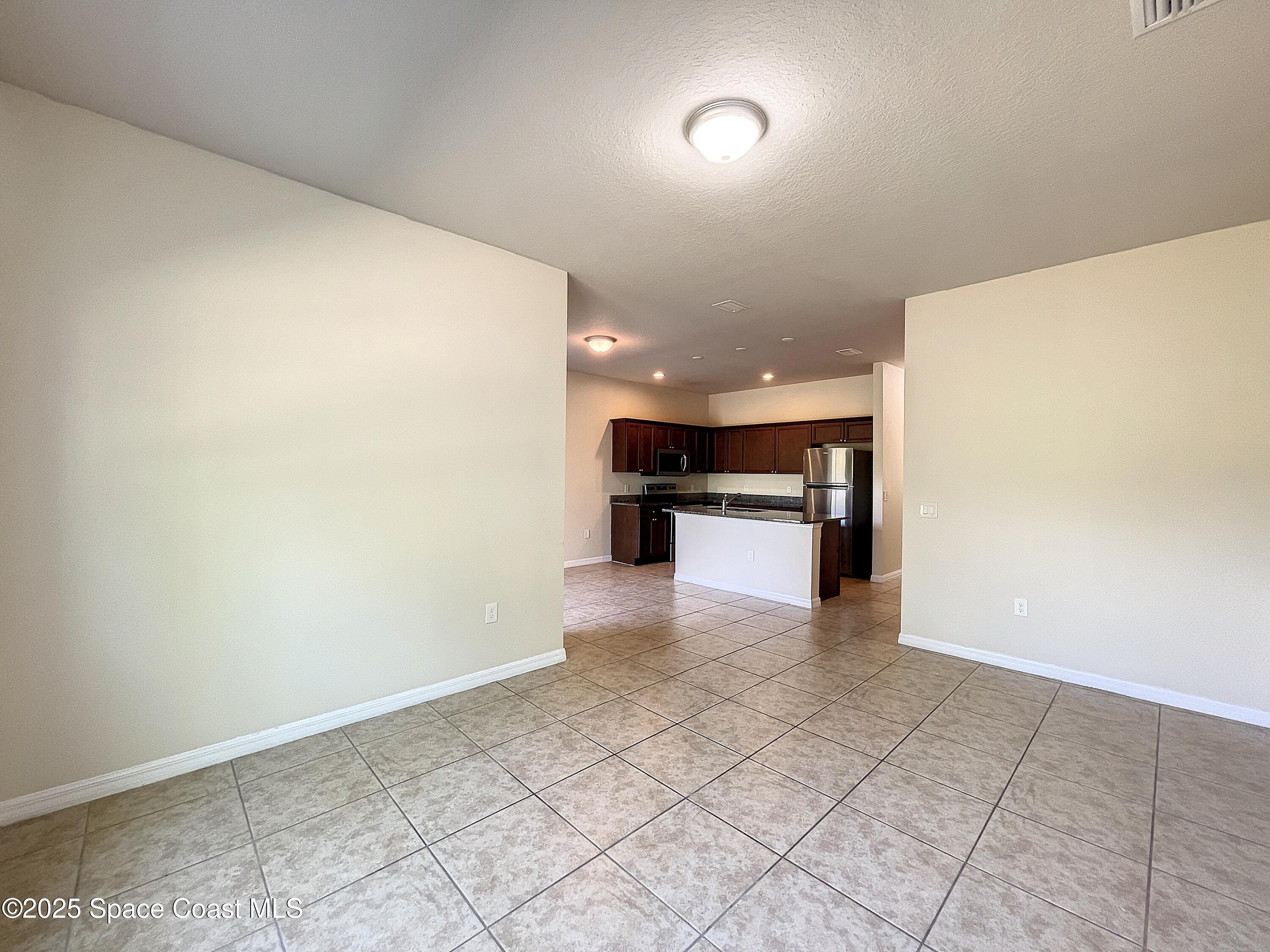 3737 Chambers Lane, Unit 3 Cocoa, FL 32926 - Photo 9 of 25 a view of kitchen with refrigerator and a sink