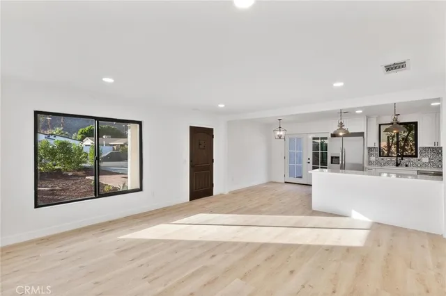 a view of kitchen with furniture and a large window