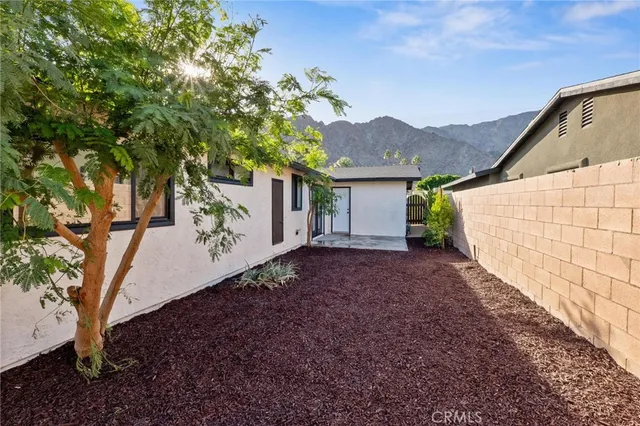 a view of a house with a yard and floor to ceiling window