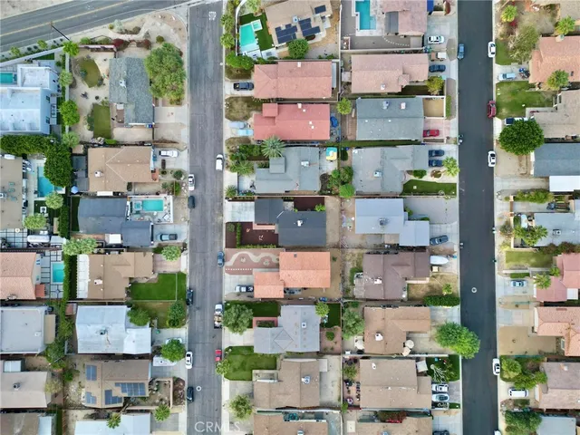 an aerial view of residential houses with outdoor space