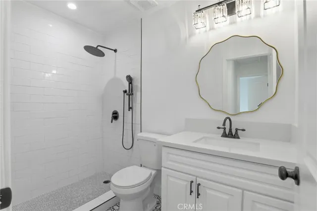 a bathroom with a sink toilet and a mirror