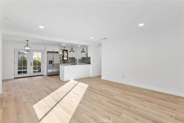 a view of a kitchen with a sink and a refrigerator