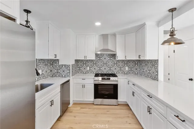 a kitchen with white cabinets and white appliances