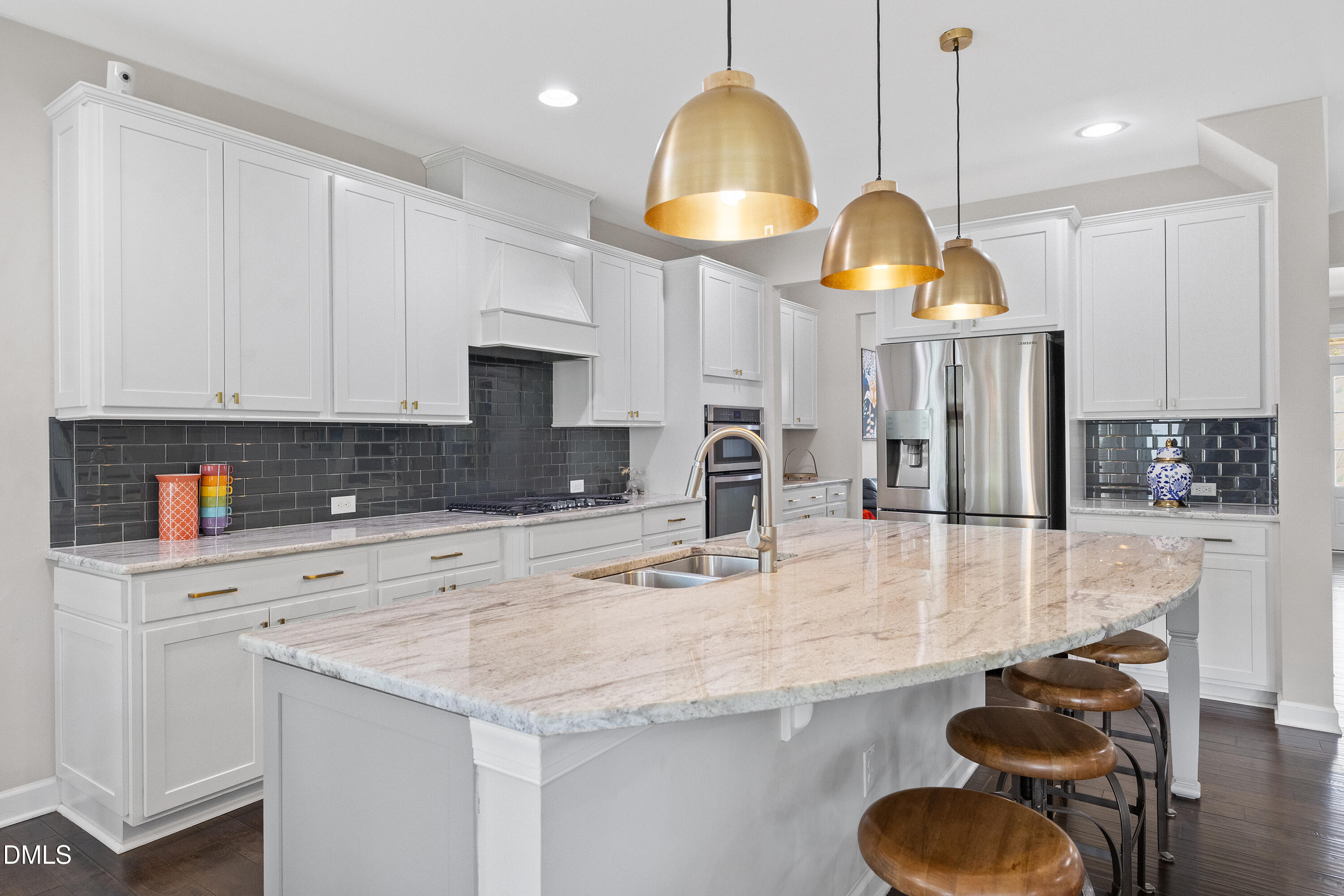 8059 Gilano Drive Raleigh, NC 27603 - Photo 15 of 43 a kitchen with stainless steel appliances granite countertop a sink a stove and a wooden floors