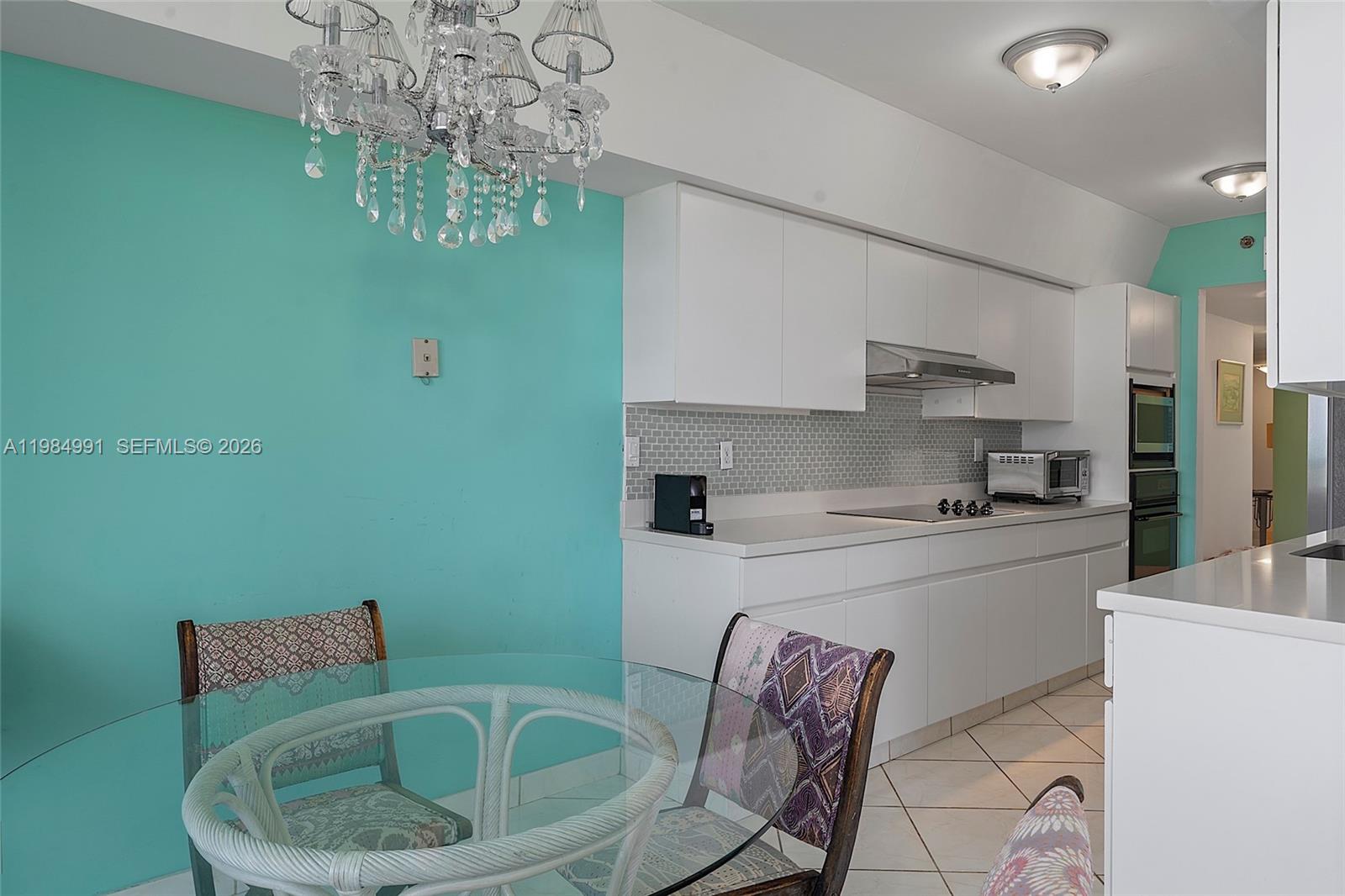 9455 Collins Avenue, Unit 409 Surfside, FL 33154 - Photo 11 of 46 a kitchen with a sink and cabinets