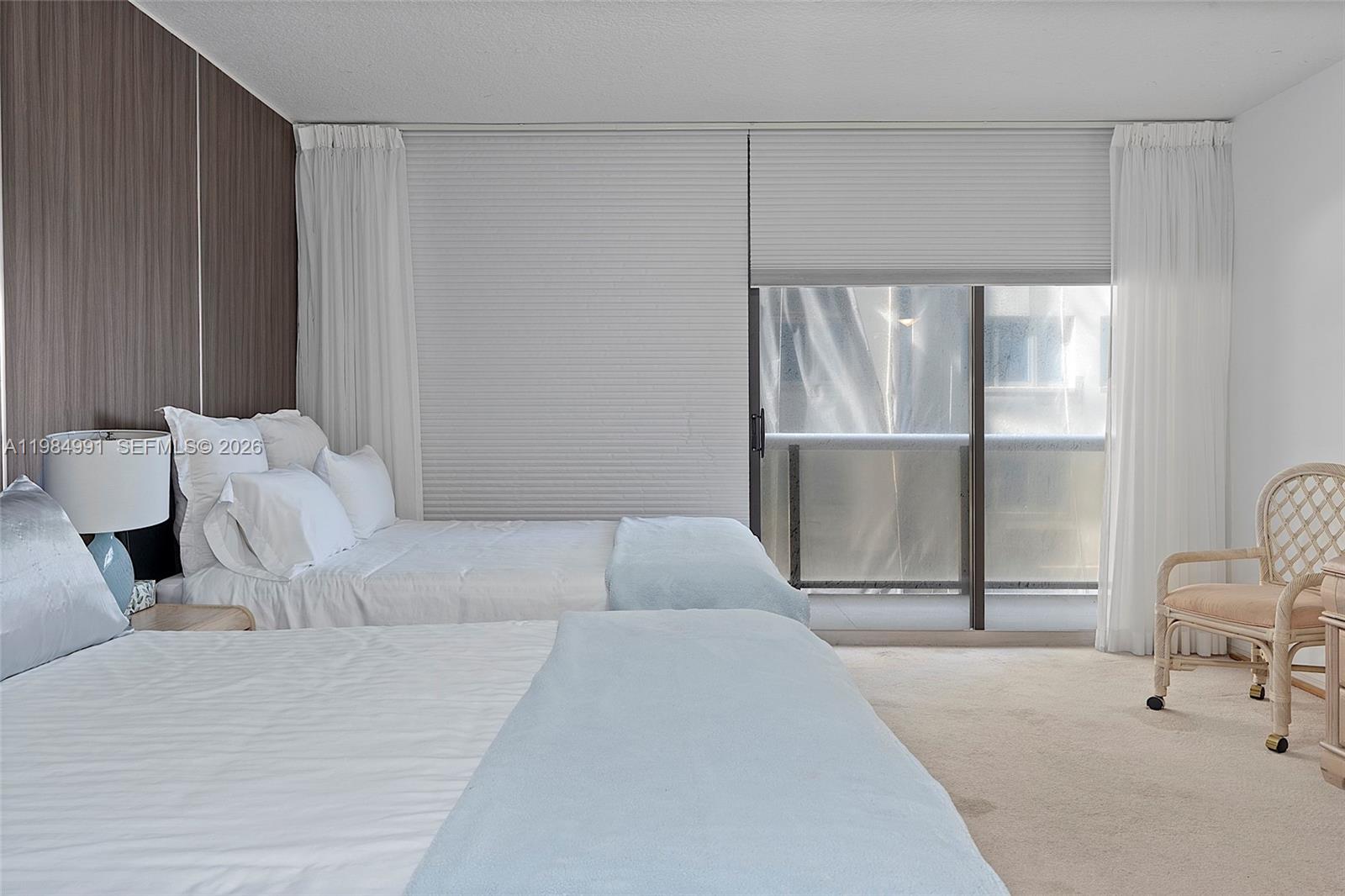 9455 Collins Avenue, Unit 409 Surfside, FL 33154 - Photo 18 of 46 a bedroom with a large bed and a window