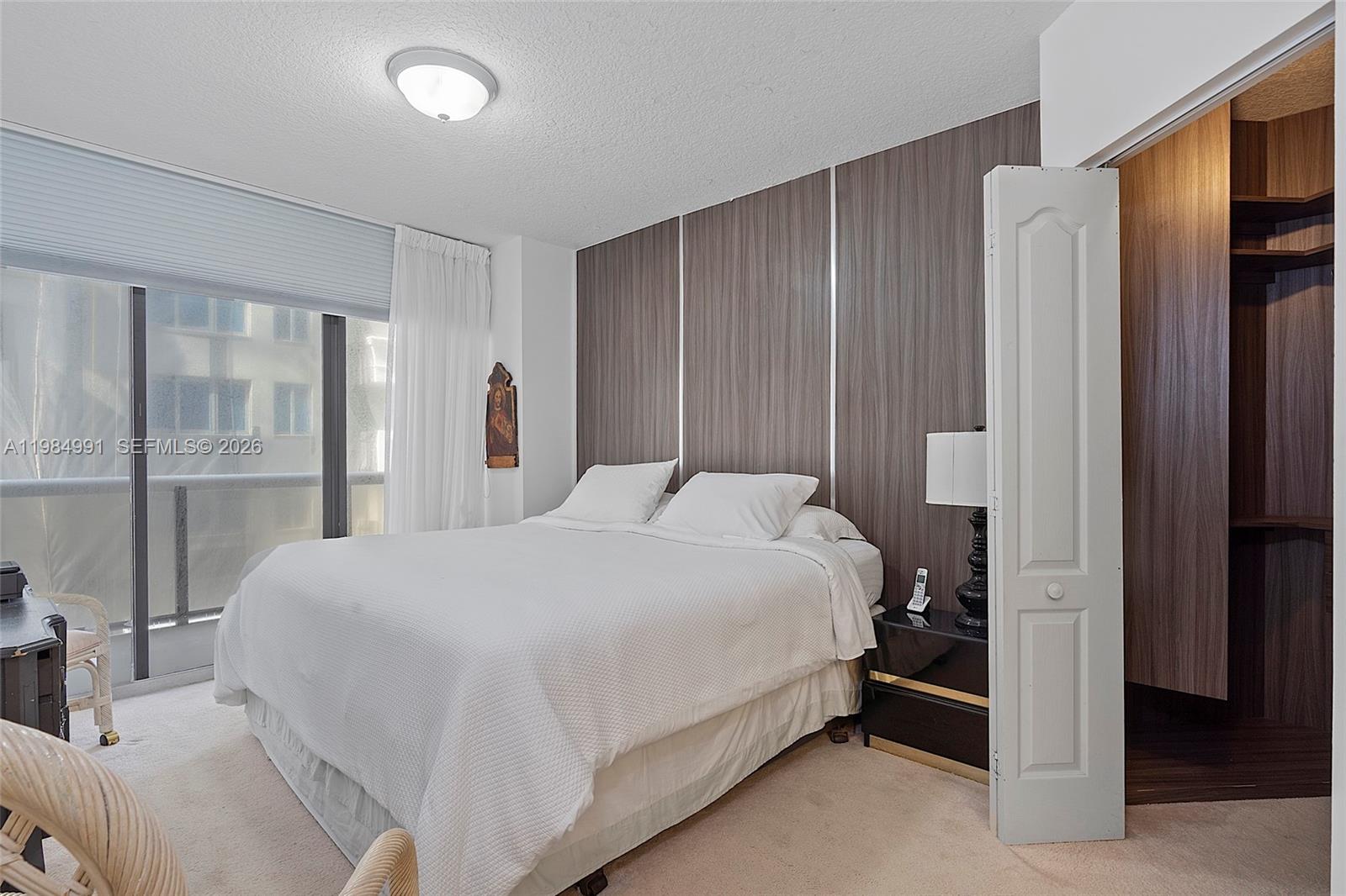 9455 Collins Avenue, Unit 409 Surfside, FL 33154 - Photo 24 of 46 a bedroom with a large bed and a closet