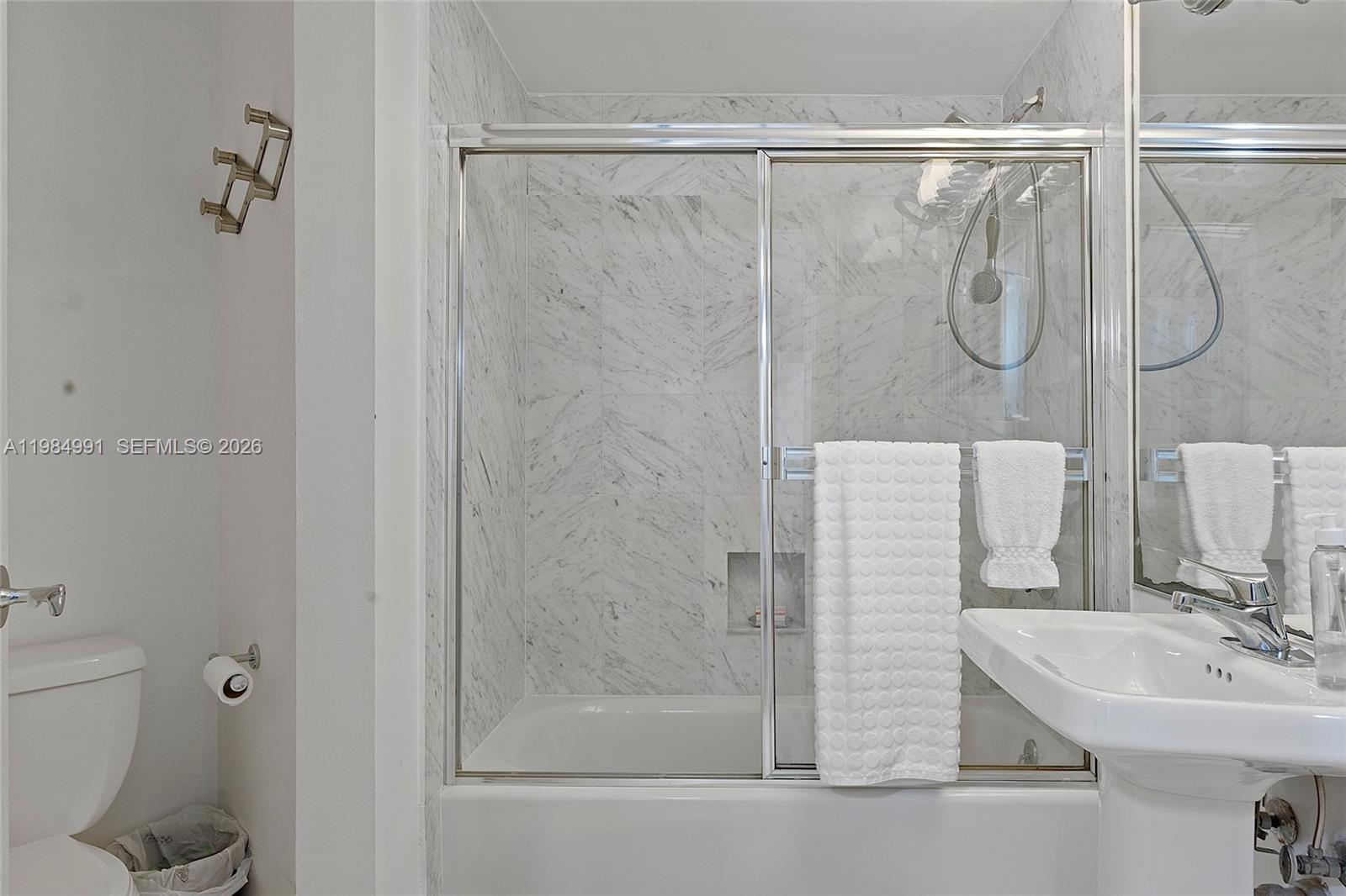 9455 Collins Avenue, Unit 409 Surfside, FL 33154 - Photo 26 of 46 a bathroom with a shower and a sink