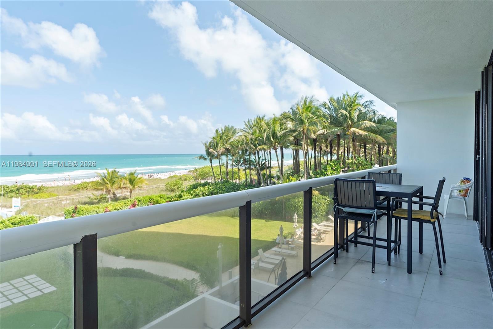9455 Collins Avenue, Unit 409 Surfside, FL 33154 - Photo 3 of 46 a view of a chairs and table in the balcony