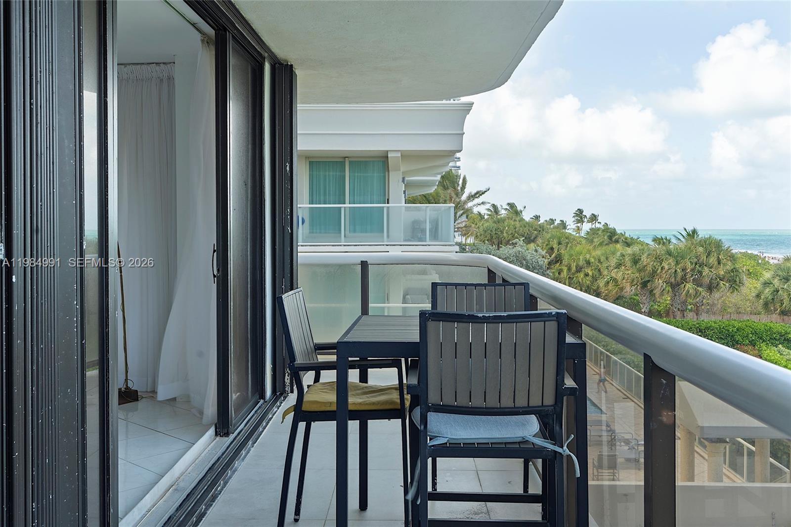 9455 Collins Avenue, Unit 409 Surfside, FL 33154 - Photo 40 of 46 a view of balcony with wooden floor and outdoor seating