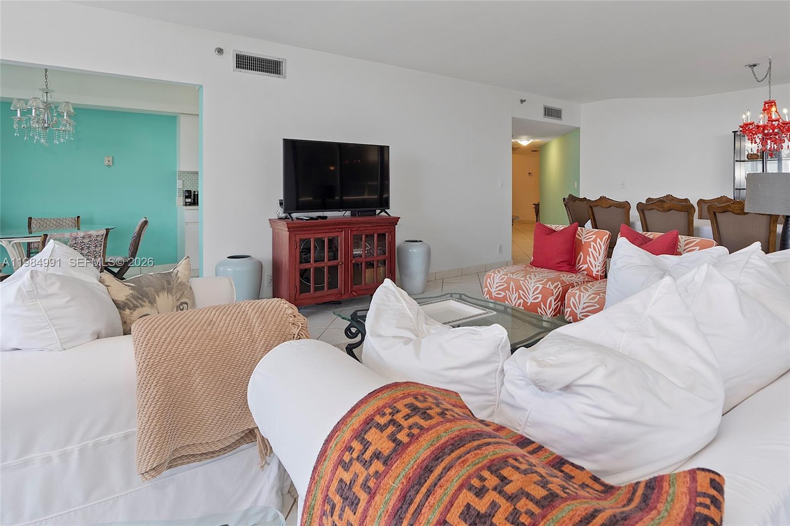 9455 Collins Avenue, Unit 409 Surfside, FL 33154 - Photo 41 of 46 a living room with furniture and a flat screen tv