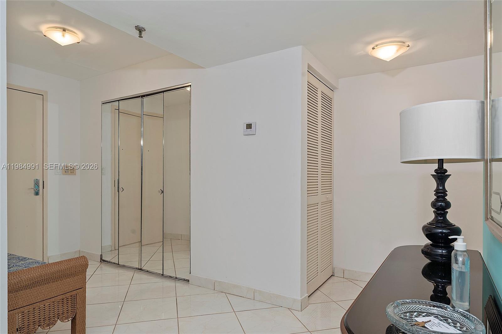 9455 Collins Avenue, Unit 409 Surfside, FL 33154 - Photo 44 of 46 a view of a hallway with closet and wooden floor
