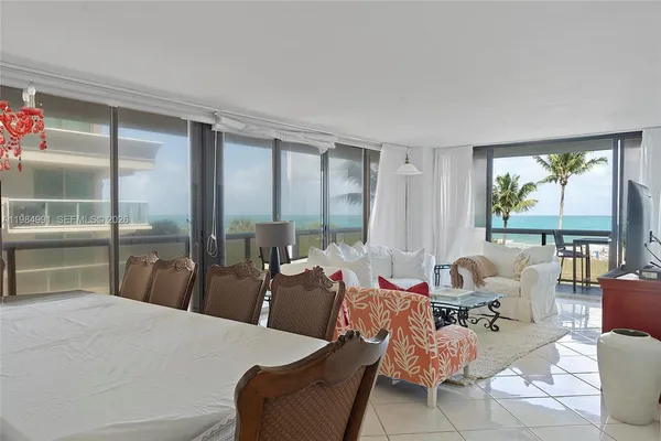 a bedroom with furniture and a large window