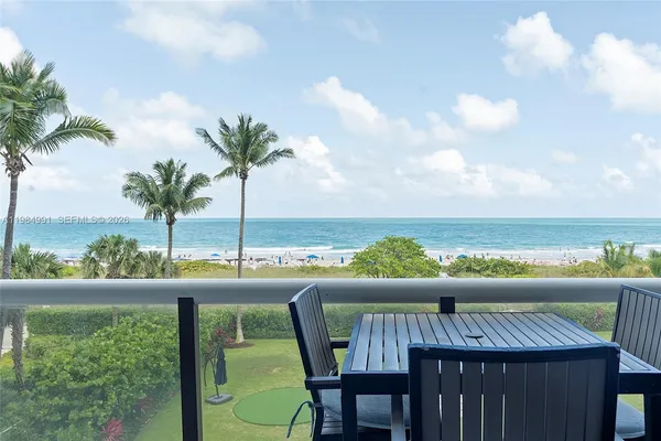 a kitchen with a table chairs and outdoor shower