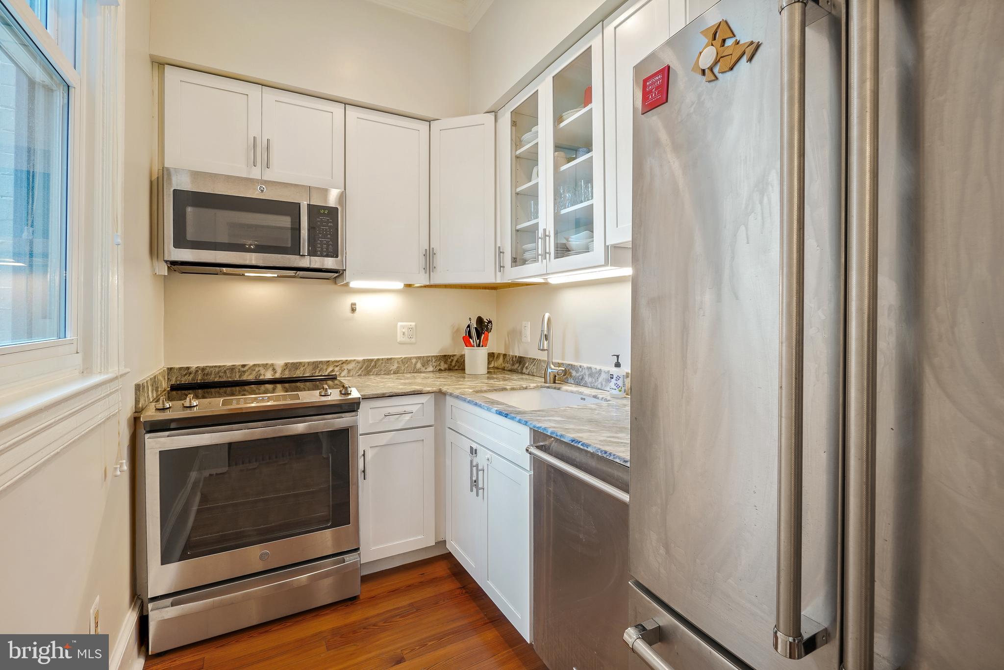 520 E Street Northeast, Unit 105 Washington, DC 20002 - Photo 13 of 30 a kitchen with stainless steel appliances granite countertop a stove and a microwave