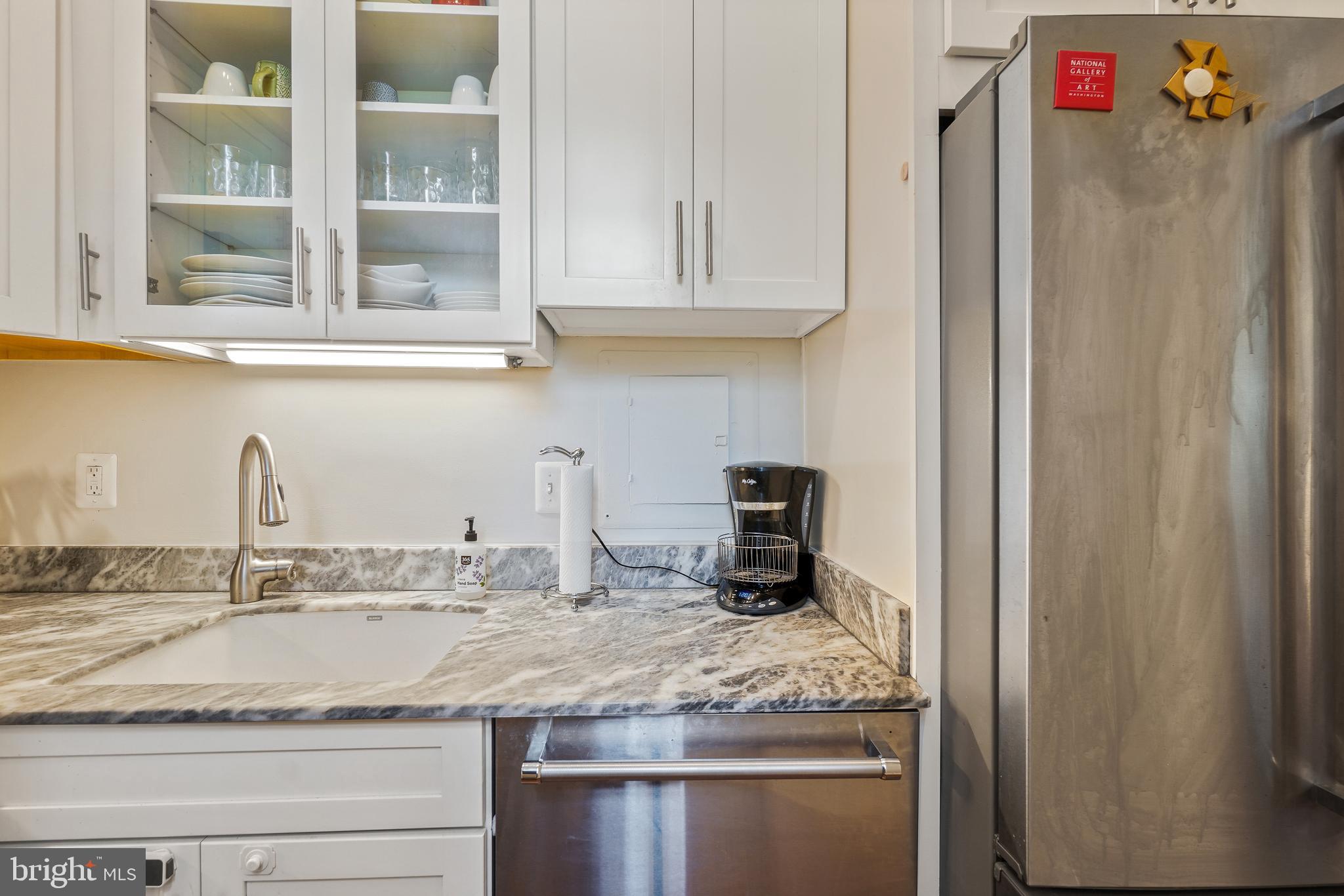 520 E Street Northeast, Unit 105 Washington, DC 20002 - Photo 15 of 30 a bathroom with a granite countertop sink and a mirror