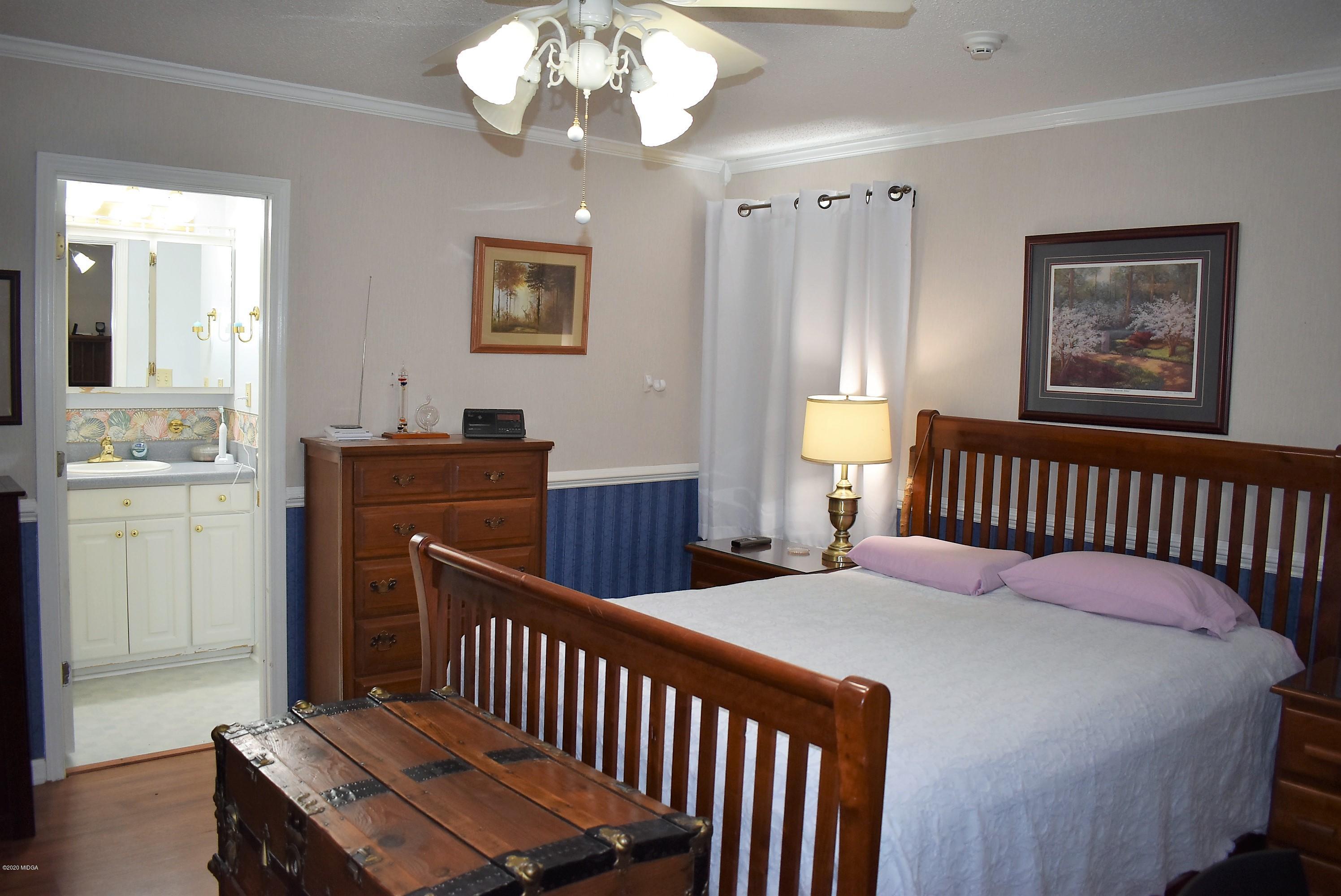 4825 Brookhaven Road Macon, GA 31206 - Photo 14 of 30 a bedroom with bed and wooden floor