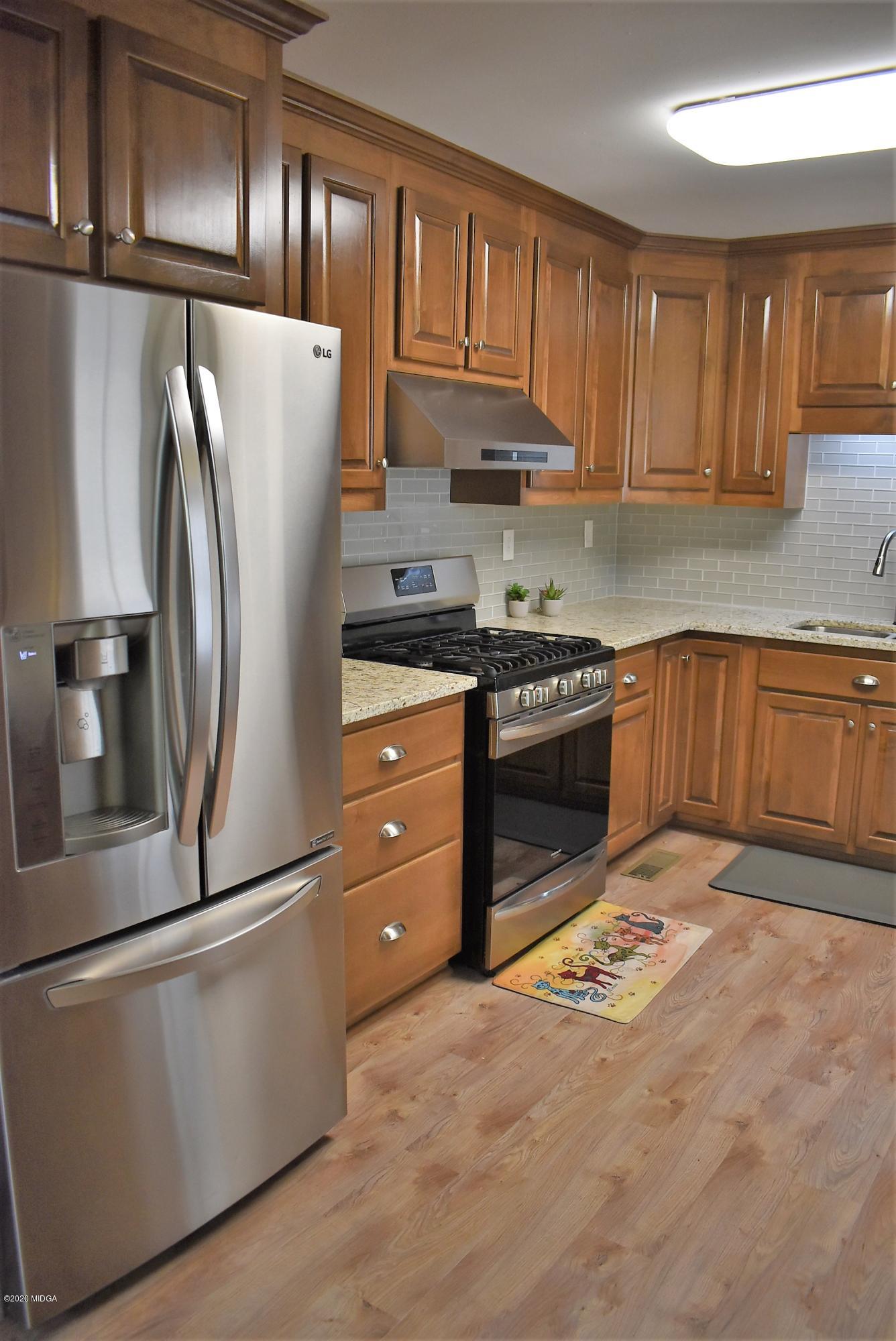 4825 Brookhaven Road Macon, GA 31206 - Photo 7 of 30 a kitchen with stainless steel appliances granite countertop a refrigerator sink and cabinets