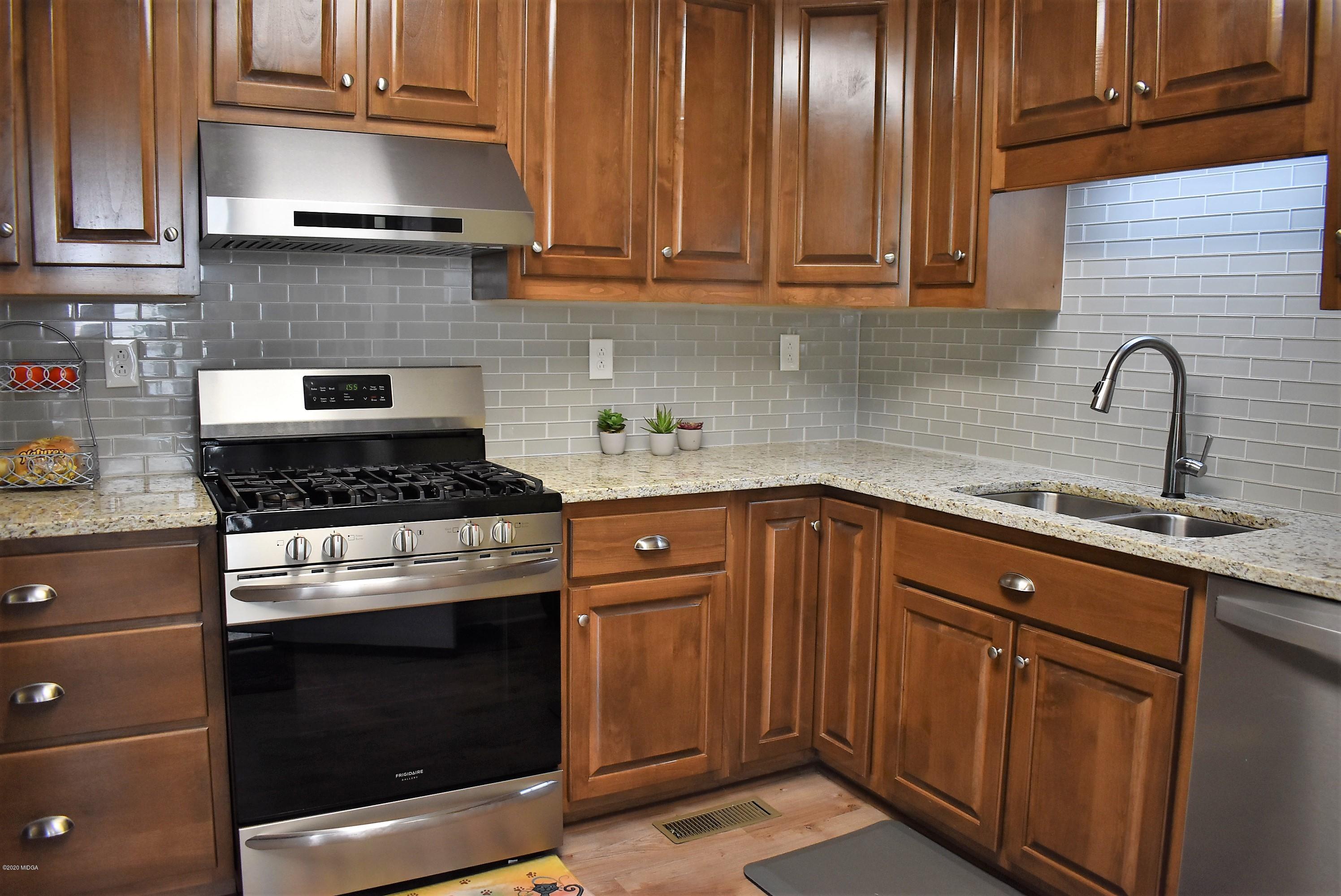 4825 Brookhaven Road Macon, GA 31206 - Photo 10 of 30 a kitchen with granite countertop wood cabinets stainless steel appliances and a sink