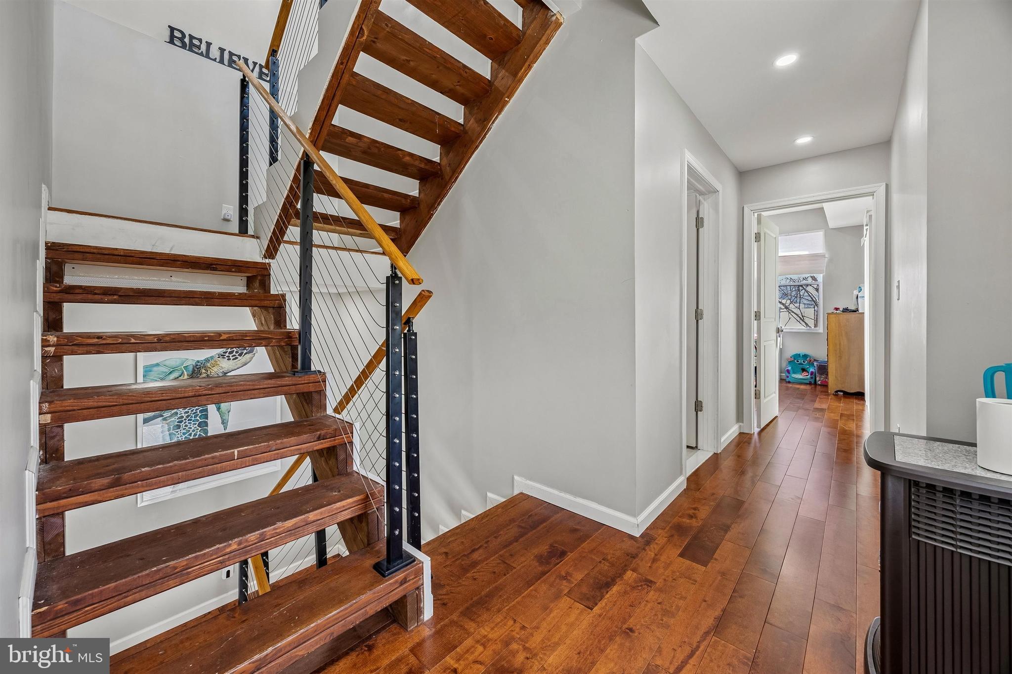 217 Grape Street Philadelphia, PA 19128 - Photo 11 of 27 a view of a hallway with wooden floor and staircase