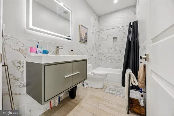 a bathroom with a sink toilet and shower