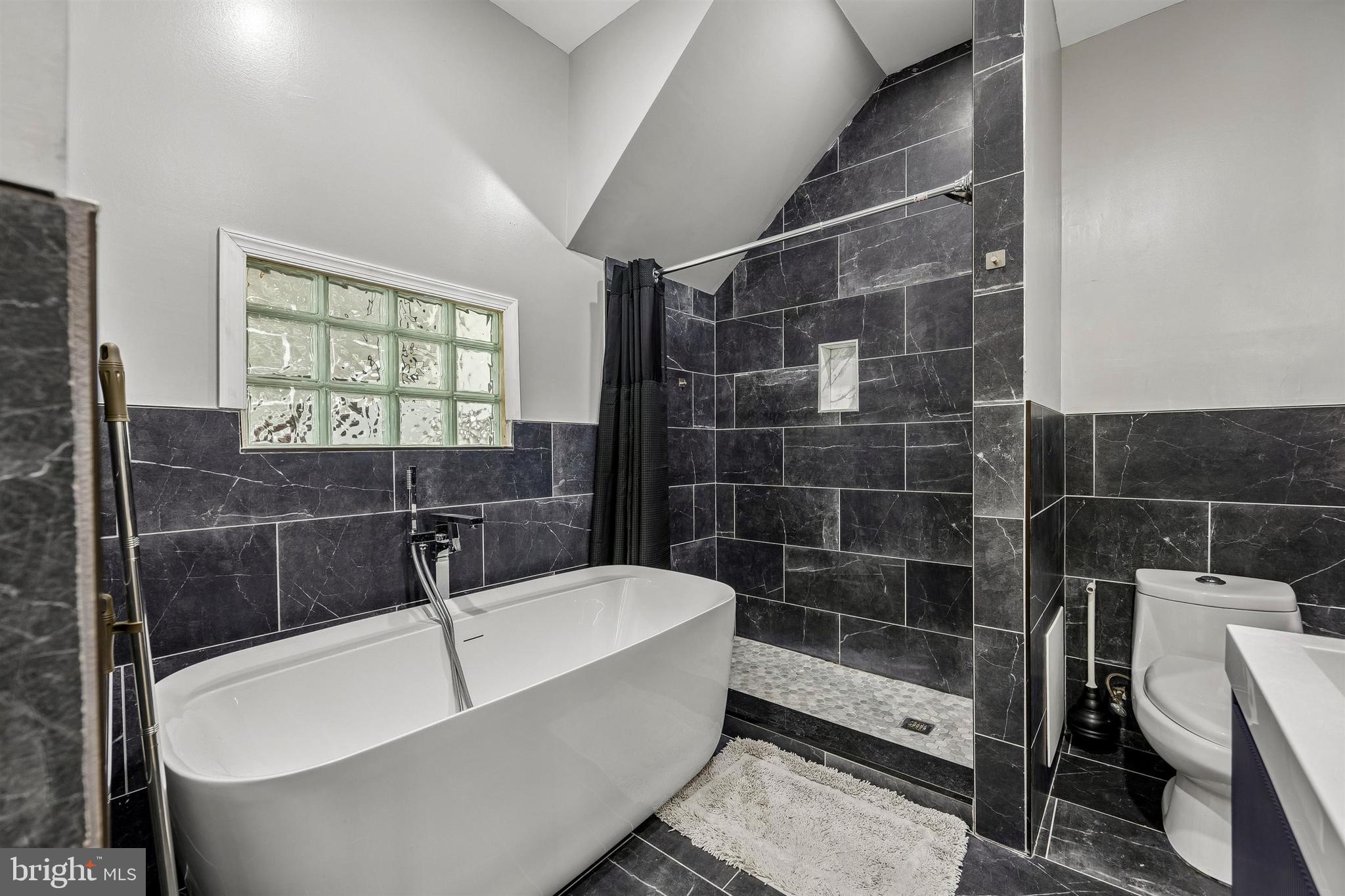 217 Grape Street Philadelphia, PA 19128 - Photo 19 of 27 a bathroom with a bathtub and shower