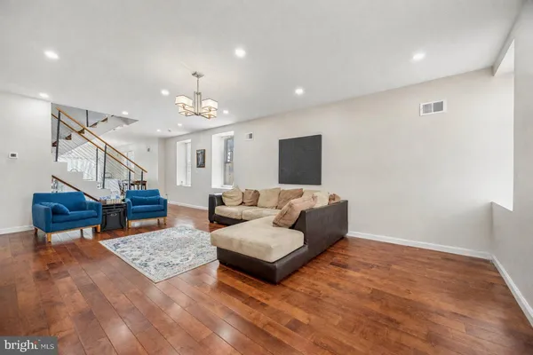 a living room with furniture and a chandelier