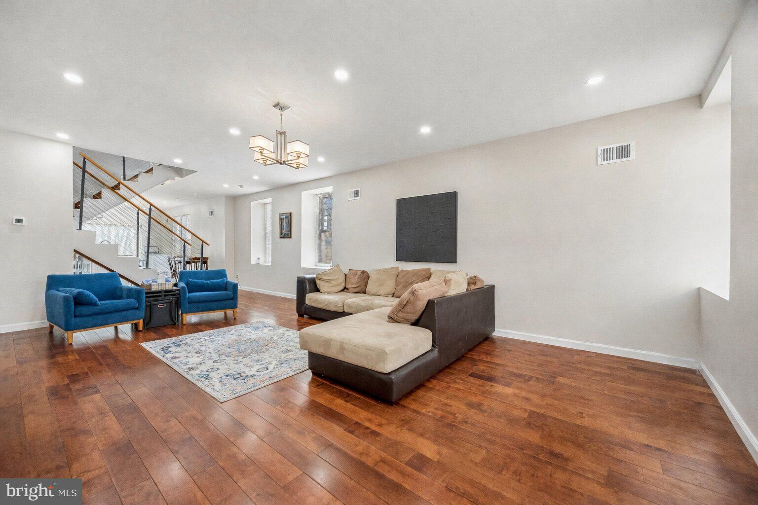 217 Grape Street Philadelphia, PA 19128 - Photo 3 of 27 a living room with furniture and a chandelier