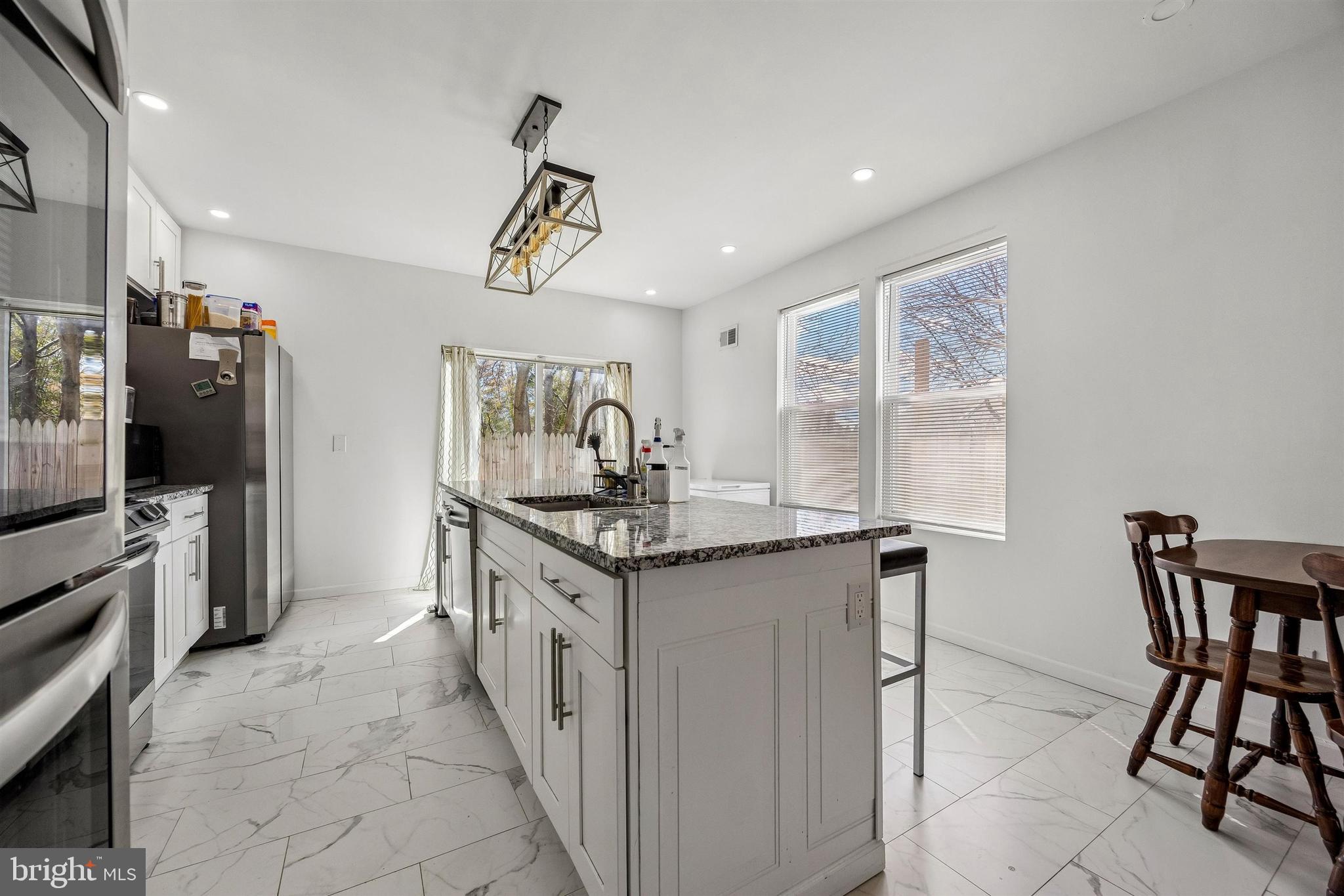 217 Grape Street Philadelphia, PA 19128 - Photo 6 of 27 a kitchen with stainless steel appliances granite countertop a stove a sink and a refrigerator