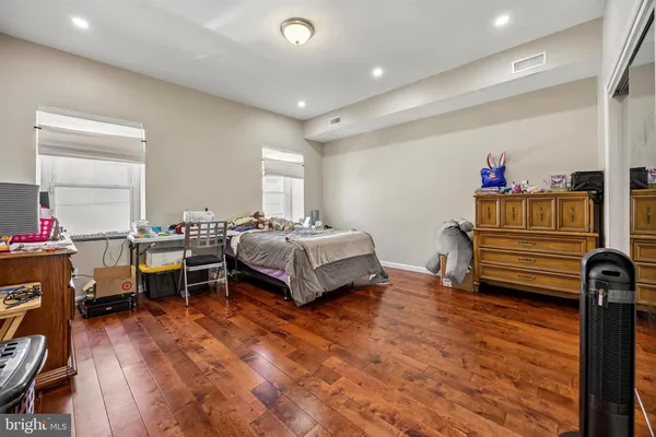 a bedroom with furniture and a wooden floor