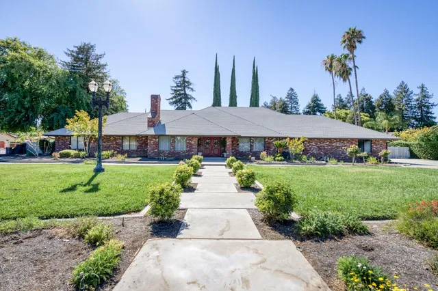 a kitchen with stainless steel appliances granite countertop a sink and a stove