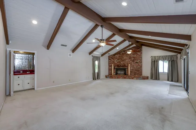 a view of a chandelier and a chandelier fan in big room