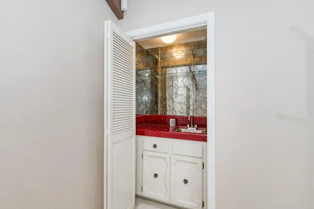 a bathroom with a tub a double vanity sink and mirror