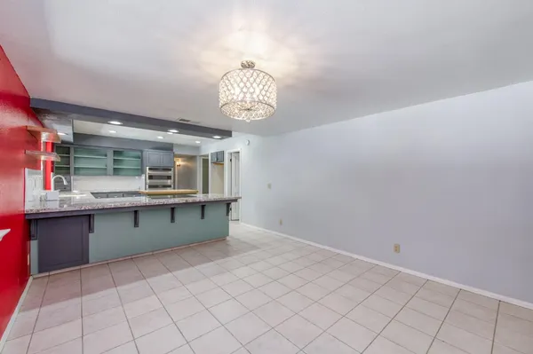 a bathroom with a sink double vanity granite tub shower and mirror