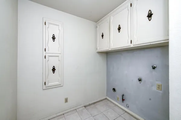 a backyard of a house with barbeque oven and outdoor seating