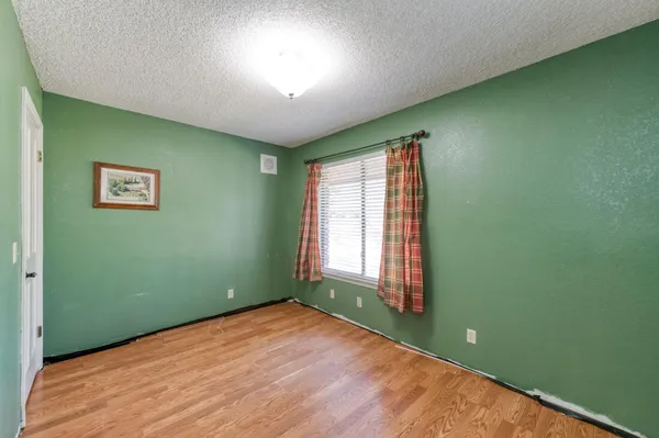 a view of a backyard with large trees