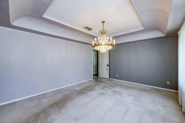 a view of a patio with a table chairs and a small yard