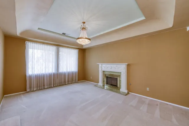 a view of a patio with couches table and chairs under an umbrella with a barbeque
