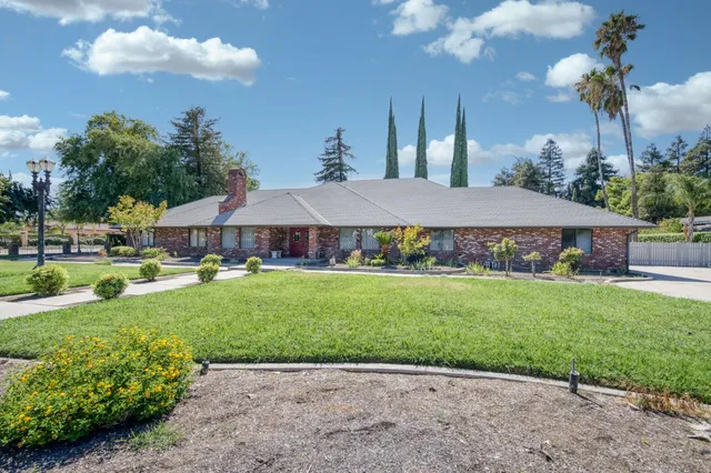 a front view of a house with garden and porch
