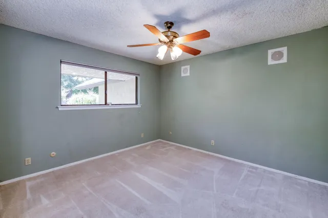an aerial view of a house with a yard lake view and mountain view in back