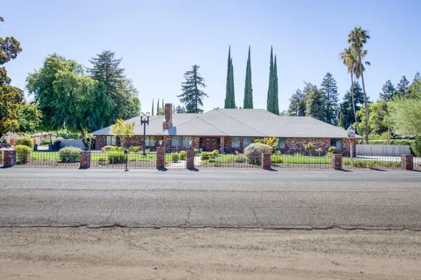 a view of a house with a yard and sitting area