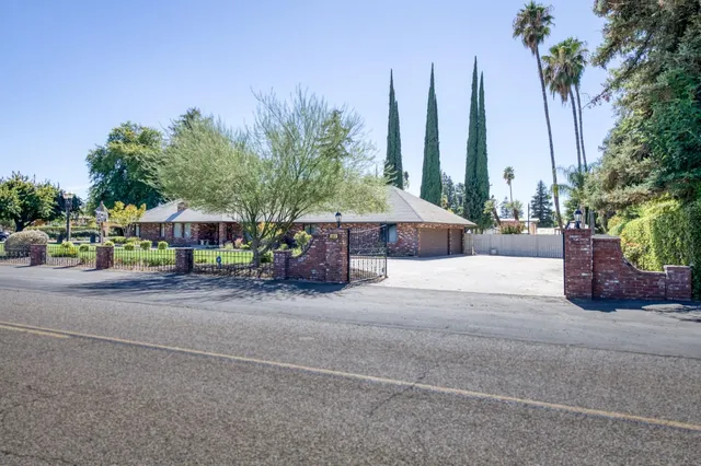 a view of empty room with a fireplace and fan