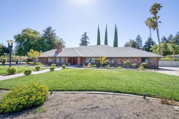 a kitchen with stainless steel appliances granite countertop a sink and a refrigerator